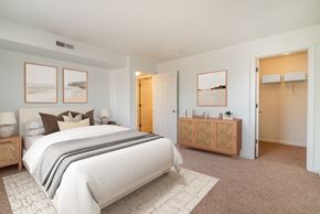 Minnetonka apartment for rent - A bedroom with a large bed and a wooden cabinet.
