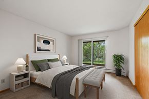 Plymouth apartment for rent - a bedroom with a bed and a large window