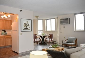 St. Paul apartment for rent - A living room with a dining table and chairs.