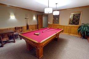La Crosse apartment for rent - a red pool table in a room with a wooden table and chairs
