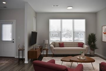 Inver Grove Heights townhouse for rent - A living room with a red couch and a television.