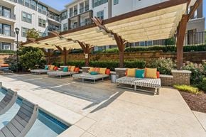Fort Mill apartment for rent - a group of lounge chairs under a large canopy next to a pool at Beckett Farms Apartments, PRG Real Estate Management, Fort Mill, 29715
