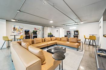 A modern living room with a tan sofa set and a coffee table