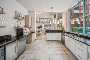 Richmond apartment for rent - A modern kitchen with a black countertop and white cabinets. at The Locks, Richmond