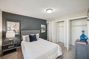Charlotte apartment for rent - A bedroom with a large bed and a painting on the wall at Willow Ridge Apartments, North Carolina, 28210