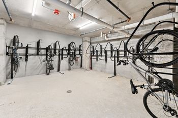 A bike shop with many bicycles hanging on the wall