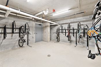 A bike parking area with bikes hanging on the wall