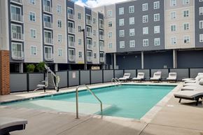Hampton apartment for rent - a swimming pool in front of a building at The Constellation Apartments, PRG Real Estate, Hampton, Virginia
