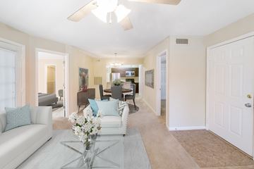 Virginia Beach apartment for rent - A living room with a white couch and a glass coffee table.