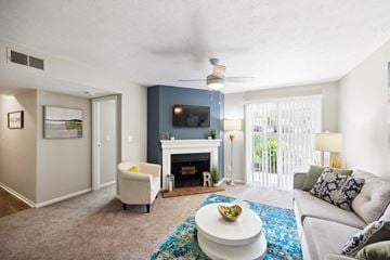 Louisville apartment for rent - the preserve at ballantyne commons living room with fireplace and couch