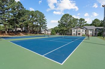 A tennis court with a green and blue surface
