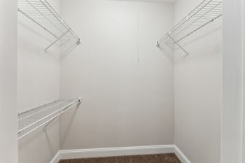 Empty white shelves in a room.