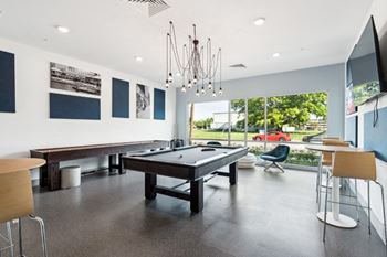 A room with a pool table and a tv