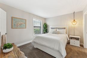 Charleston apartment for rent - A bedroom with a large bed and a painting on the wall at Sawgrass Apartments, Charleston, SC, 29412