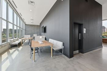 A modern room with a long table and chairs.