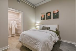 Richmond apartment for rent - A bedroom with a white bed and a green headboard at The Carousel Apartments, Richmond, Virginia