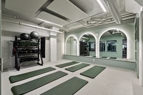 Richmond apartment for rent - A gym with green mats and a weight rack at The Carousel Apartments, Virginia