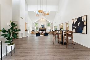 Charlotte apartment for rent - the gathering place at gardner village community room with white walls and wood flooring  at Willow Ridge Apartments, Charlotte, NC