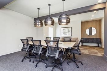 A conference room with a long wooden table and chairs