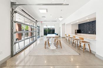 A modern dining room with a long table and chairs