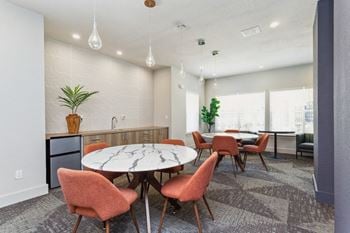 A dining room with a table and chairs