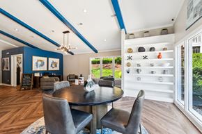 Cary apartment for rent - A modern dining room with a round table and chairs. at Woodcreek Apartments, North Carolina