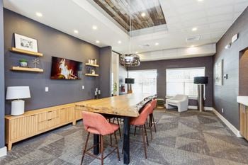 A dining room with a table and chairs and a fireplace