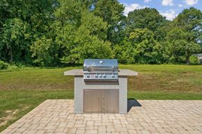 Richmond apartment for rent - A brick patio with a built in BBQ grill at Staples Mill Townhomes Apartments, Richmond, Virginia