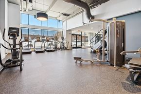 Richmond apartment for rent - a gym with cardio equipment and windows in a building  at The Box, Virginia