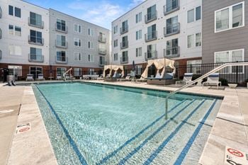 A swimming pool in front of apartment buildings