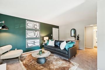 Cary apartment for rent - A living room with a black couch and a brown rug.
