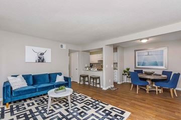 Charleston apartment for rent - A blue couch sits in a living room with a coffee table in front of it.