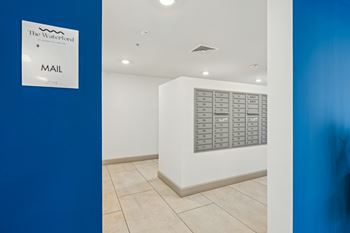 A white wall with a mail sign and a mailbox