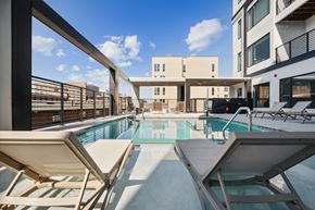Richmond apartment for rent - the pool area of a building with a swimming pool and lounge chairs  at The Box, Virginia, 23224