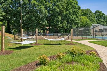 A playground with a swing set and a basketball court.