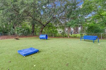 A park with a blue bench and a blue mattress.