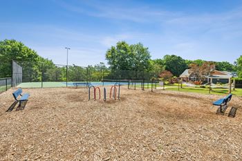A playground with a swing set and a slide.