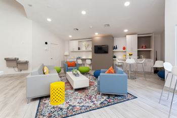 A living room with couches and chairs and a tv