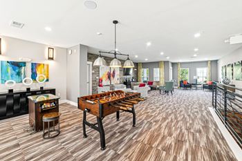 A room with a wooden floor and a pool table.