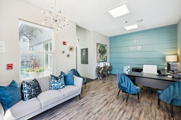 Kansas City apartment for rent - a living room with a couch chairs and a desk with a computer