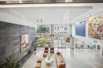Richmond apartment for rent - A modern living room with a grey wall and a painting on it.