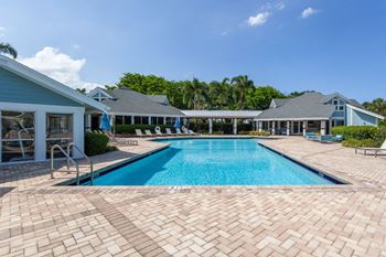 A large swimming pool in front of a house