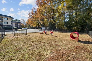 A playground with a red tunnel and two children playing
