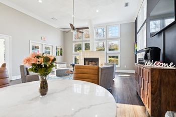 A living room with a table and a fireplace