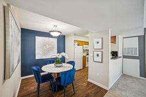 Charlotte apartment for rent - A dining room with a round table and blue chairs at Willow Ridge Apartments, North Carolina, 28210
