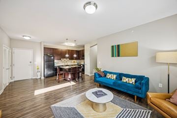 Louisville apartment for rent - A living room with a blue couch and a coffee table.