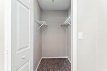 A closet with two hanging racks on the wall