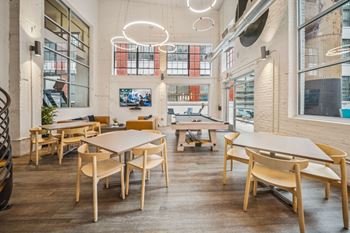 A modern dining area with wooden chairs and tables
