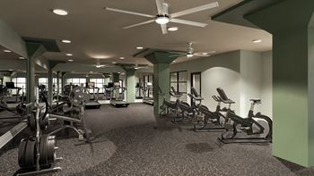 A gym with a variety of equipment including treadmills, weights, and exercise bikes