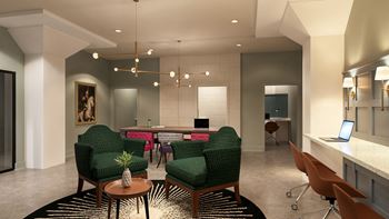 A modern office space with green chairs and a coffee table in the center